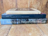 Spines showing all three art books stacked