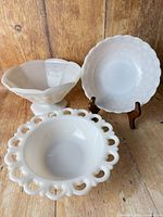 All three milk glass bowls front view showing design differences