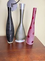 All three vases on tabletop showing shapes, colors and finishes