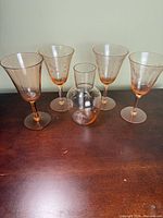 Group shot of four wine glasses and carafe
