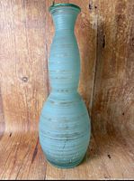Full view of tall textured seafoam green glass vase