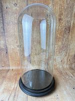 Full view of glass cloche on wood base
