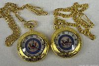 Two gold-tone pocket watches with chains