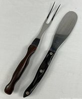 Carving fork and serrated spreader side by side