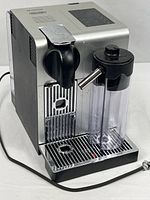 Full view of DeLonghi Nespresso EN750MB machine with milk container attached and power cord visible