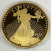Obverse of gold-tone replica coin showing Liberty and date 1934 in plastic capsule