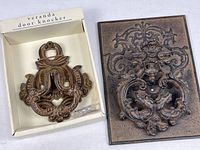 Both door knockers side by side: boxed Pier 1 Veranda and larger knocker on backplate