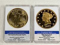 Front view of both replica coins in holders showing obverse designs and specifications cards