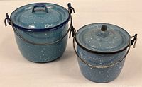 Both blue speckled enameled steel pails with lids shown side by side