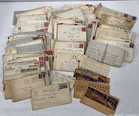 Overview of entire collection of envelopes and telegrams spread on table