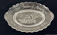 Full view of clear glass oval plate with patriotic embossing