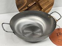 Wok interior and wooden trivet visible