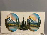 Full view of rectangular canvas with two oval alpine scenes