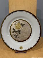 Front view of Chokin decorative plate showing gold rose design, inscription, and 24K gold rim