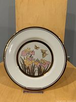 Front of plate showing floral and butterfly chokin design