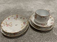 Five-piece Limoges porcelain set assembled on carpet