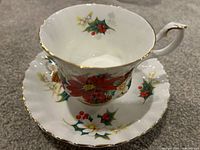 Teacup on saucer showing pattern and gold trim