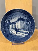 Front of 1975 Royal Copenhagen Christmas plate showing winter castle scene and 1975 year mark