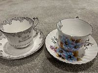 Two teacup and saucer sets side by side