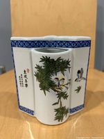 Front view showing bird and bamboo motif, calligraphy panel, blue borders