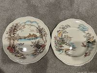 Front view of both plates showing European Conway Castle scene and Asian Ming Toi scene