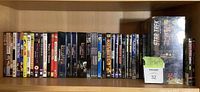 Shelf with full assortment of DVD/Blu-ray cases and Star Trek puzzle