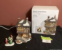 Front view of illuminated building, figurine, box visible