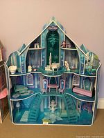 Front view of three-story Frozen castle with furniture arranged