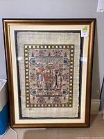 Full view of framed Egyptian papyrus painting under glass