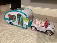 Convertible car hitched to camper trailer, overall view