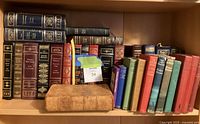 Shelf showing complete lot of leather, cloth and paperback books