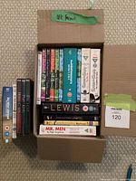 Open cardboard box showing full lot of Region 2 DVDs with additional cases alongside