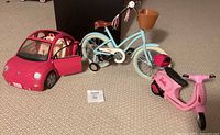 All three toy vehicles: Barbie Beetle car, Our Generation bicycle, Barbie Vespa scooter