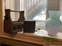 Group shot showing wood caddy, sound machine, fishbowl, frosted vase