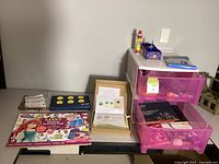 Overall view of lot including activity pad, LEGO baking set, string art kit, storage drawers with contents and Frozen box