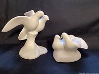 Both Royal Doulton gloss white bird figurines side by side