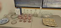 Full lot overview showing punch bowl, decanters, coupes, boxed vase, additional glassware