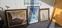 Group shot of all five framed prints leaning against wall