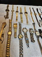 Top view of multiple women’s wristwatches aligned on towel