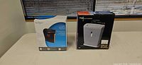 Both boxed shredders on table