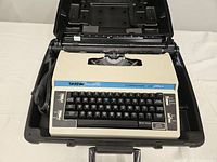 Overall view of Brother typewriter inside its hard case showing keyboard and housing