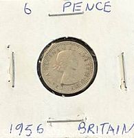 Obverse view of 1956 six pence coin showing Queen Elizabeth II portrait in holder