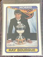 Front of Ray Bourque card showing player with Norris Trophy