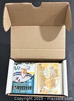 Open cardboard box showing stacks of hockey cards edge-on
