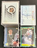 Four plastic cases showing front cards of each subset