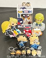 Group shot of all Funko Pop items including boxed Spider-Man, loose figures and keychain minis