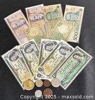 Group shot of all laminated banknotes and six coins
