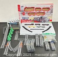 Box, foam insert, track pieces, train cars and accessories displayed