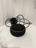 Amazon Echo Dot with power adapter visible