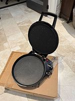 Open FlavorChef grill showing interior non-stick plates and overall condition